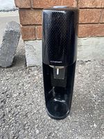 Front view of black SodaStream machine standing upright