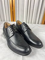 Three-quarter view of both shoes showing uppers, laces and overall condition