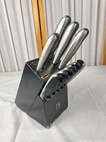 Block with knives inserted, shows overall set and wear on block finish