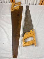 Two hand saws side by side showing full length and handles