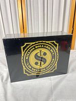 Front of black box with gold emblem