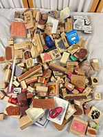 Entire mixed pile of wood stamps, clear stamps, ink pads and accessories on table