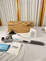 Complete massager kit with dock, attachments, charger, manuals and box