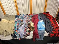 Full spread of 11 clothing pieces laid out on table