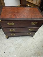 Front and top view of dresser showing veneer and brass hardware