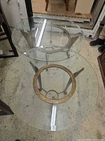 Top view of round glass table showing glass surface and metal base