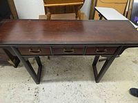 Full top and leg view of dark brown console table