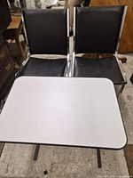 Overall view showing pair of chairs behind side table