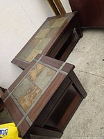 Rectangular coffee table and square end table together showing slate tile tops and shelves