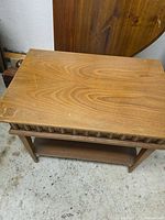 Top view of light brown wooden end table showing grain pattern and minor scratches