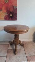 Full view of round pedestal table showing overall design and base