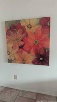 Front view of square floral canvas on wall