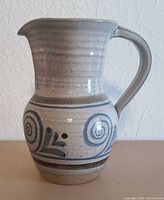 Profile of stoneware pitcher showing glaze and blue swirl design