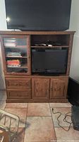 Front view showing entire entertainment center, shelving, drawers, and cabinet doors