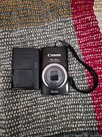 Front view of Canon camera with charger