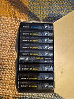 Open 10-pack sleeve showing stacked sealed Sony DT-120RA and DT-90RA cassettes