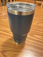 Front view of navy Yeti 30oz tumbler showing logo and body