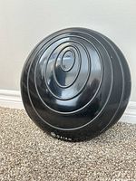 Front view of black Gaiam balance disc showing concentric ring texture and logo