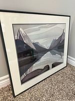 Framed Lawren Harris print leaning against wall, full view