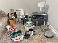 Group shot of all kitchen items showing air fryer, rice cooker, pitcher, drinkware, utensils and accessories