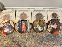 Front view of four plates with boxes behind