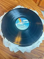 Stack of vinyl LPs separated by paper towels, top record shows MCA rainbow label