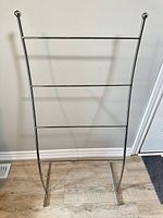Front view of silver-tone rack with four rungs