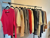 Full rack showing all fourteen sweaters and cardigans