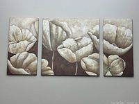 Frontal view of three floral canvas panels on wall