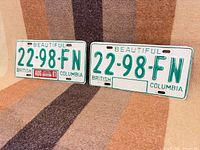 Both license plates front view on fabric background