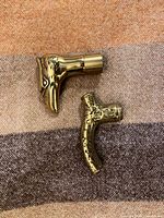 Top view of both brass handles showing shapes and threaded ends