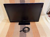 Front view of 24-inch Insignia monitor with power cord