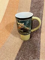 Full view of mug front showing fish illustration