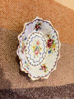 Top view showing scalloped shape, floral and geometric Petit Point pattern