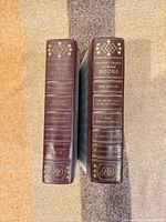 Spines showing titles, burgundy color and gilt text