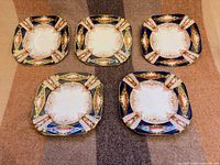 Five Royal Albert square plates front view