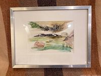 Front view of framed watercolor landscape with mat and silver aluminum frame
