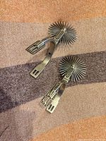 Top view showing full pair of spurs with rowels and decorative bands