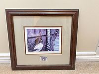 Full view of framed print showing frame, mat, artwork and stamp