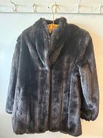 Front view of black faux fur coat