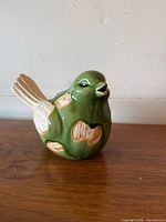 front left view of green ceramic bird figurine