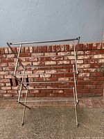 Front view of metal folding drying rack fully opened