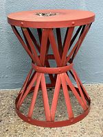 Hourglass-shape red metal table showing base structure