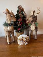 Two straw reindeer, tabletop tree, resin snow scene displayed
