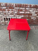 overhead front view of square red folding table