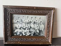 Full view of framed photograph showing baseball team image and ornate wooden frame