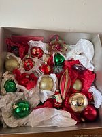 Box overview showing assortment of vintage glass ornaments wrapped in tissue