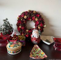 Full lot showing wreath, red glass dishes, tins, ceramic pieces, mini tree