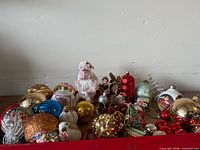 Tray overview showing porcelain dolls and full assortment of ornaments