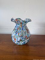 Front view of multicoloured art glass vase showing overall form and pattern